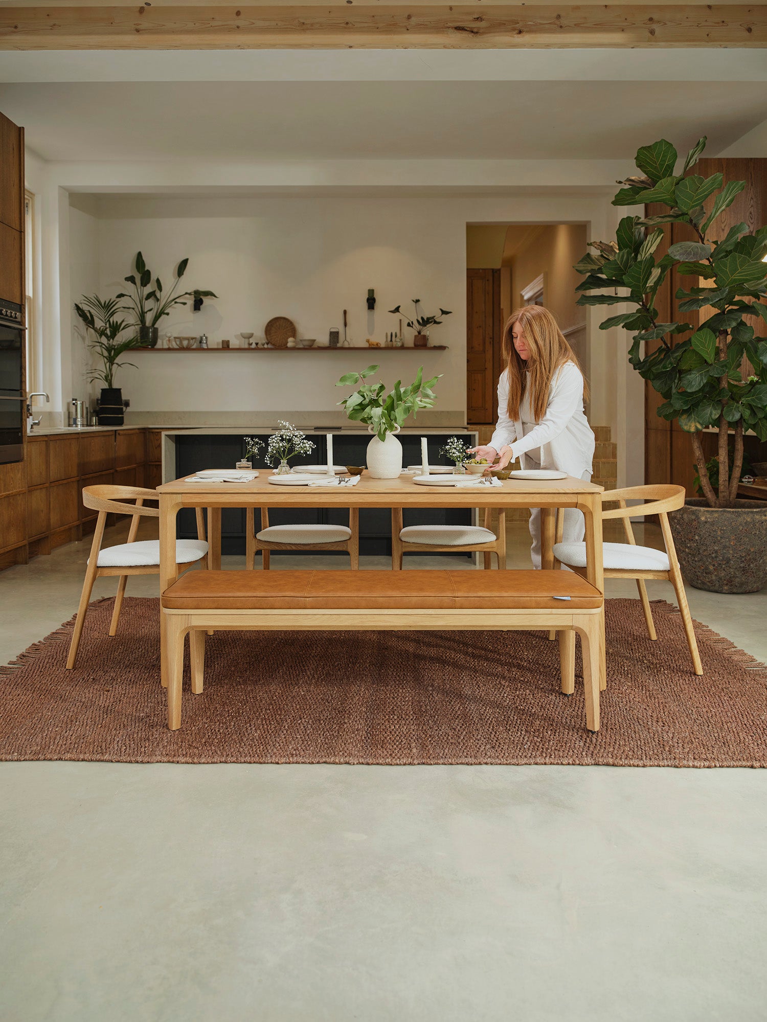 A woman setting up a dining room table