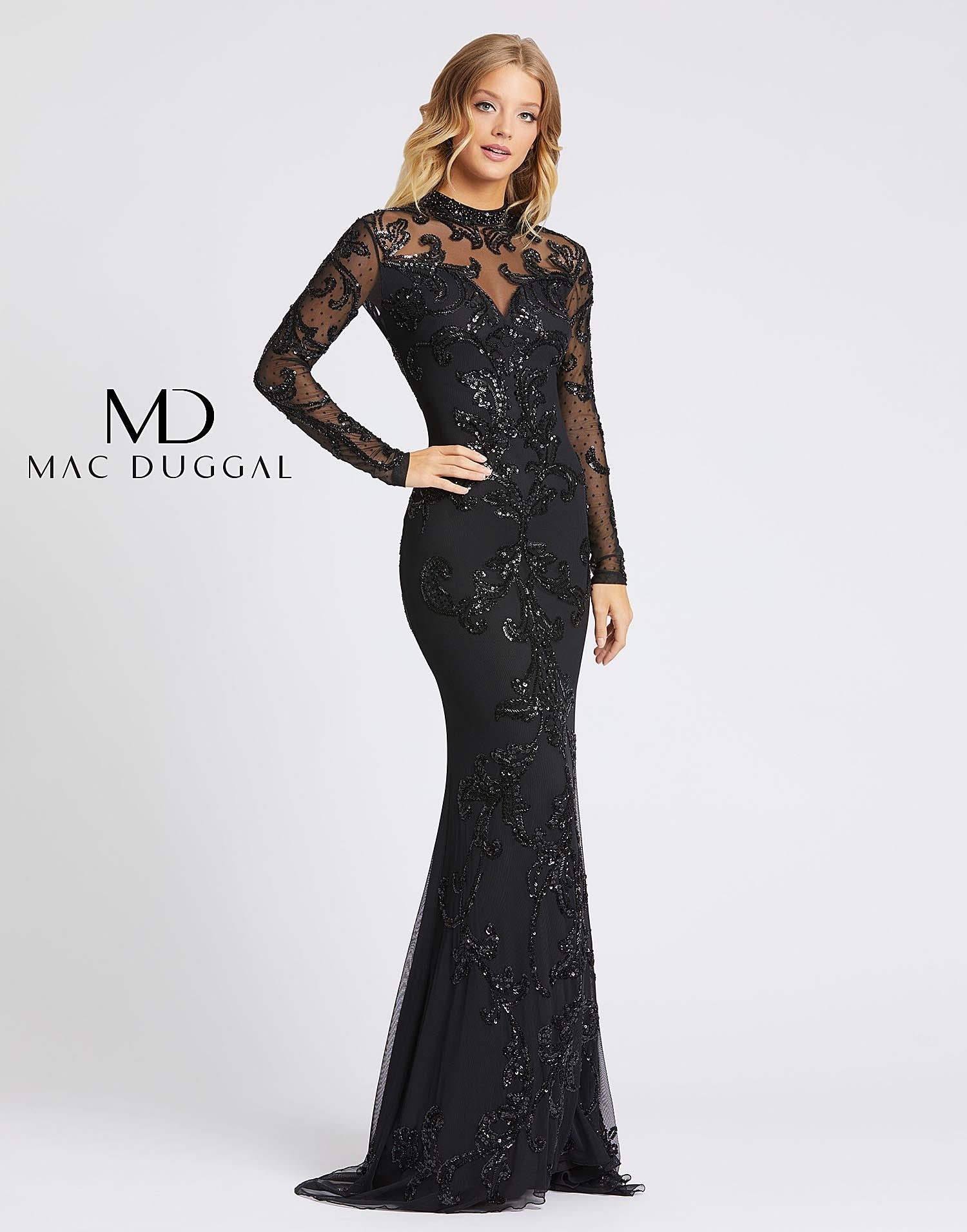 Mac Duggal Cassandra Stone 1945A is a Long Fitted Formal evening gown. Featuring speckle lace fitted long sheer sleeves with a sheer high neckline. embellished with beading & sequins. All you could ever ask for in a dress! Style 1945A has beautiful beading and an overlay of lace that gives off the impression of a sweetheart neckline. This long sleeved gown has an open back and flows into a subtle train Available Sizes: 0,2,4,6,8,10,12  Available Colors: Black