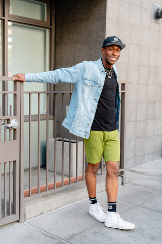 DB Model in denim jacket, shorts, and accessories