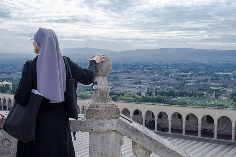 Nun overlooking Assisi's Panorama