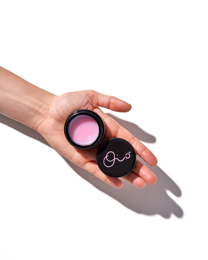 oio lab pink balm in black jar packaging