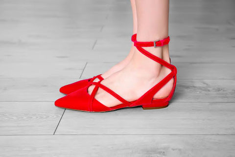 Woman wearing strappy red flats