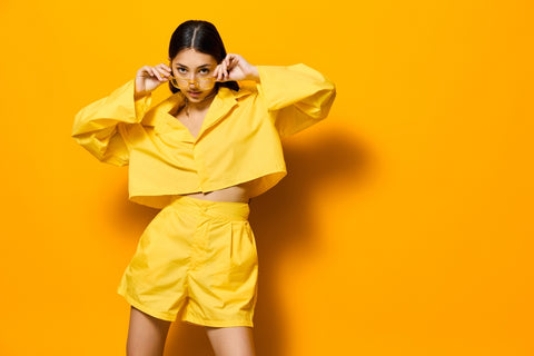 Young woman wearing a yellow monochrome outfit