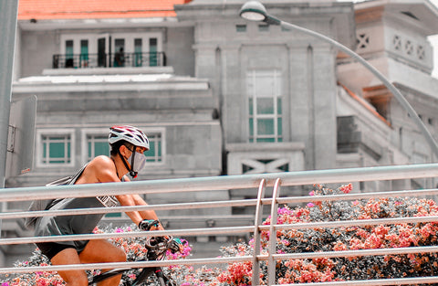 Man riding a bicycle wearing a mask