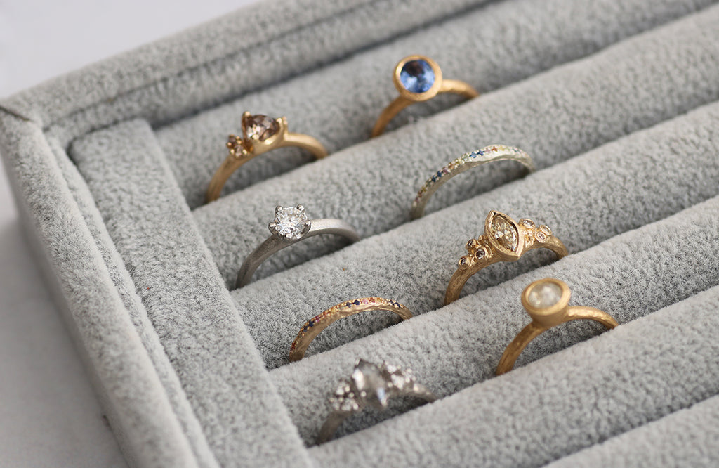 Tray of Fairtrade Gold Diana Porter Rings set with ethically Sourced Sapphires and Diamonds