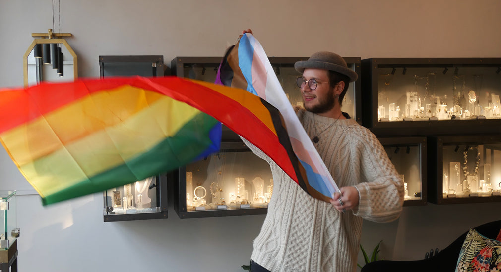 Lukas holding LGBTQIA+ flag for DianaPorter Jewellery Queer exhibition Bristol