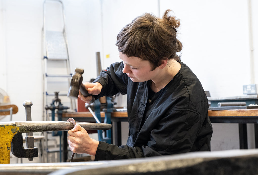 Holly Heron-Chambers working at jewellery bench Queer diana porter Jewellery