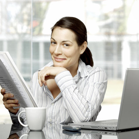 woman at desk with cleaner air quality 