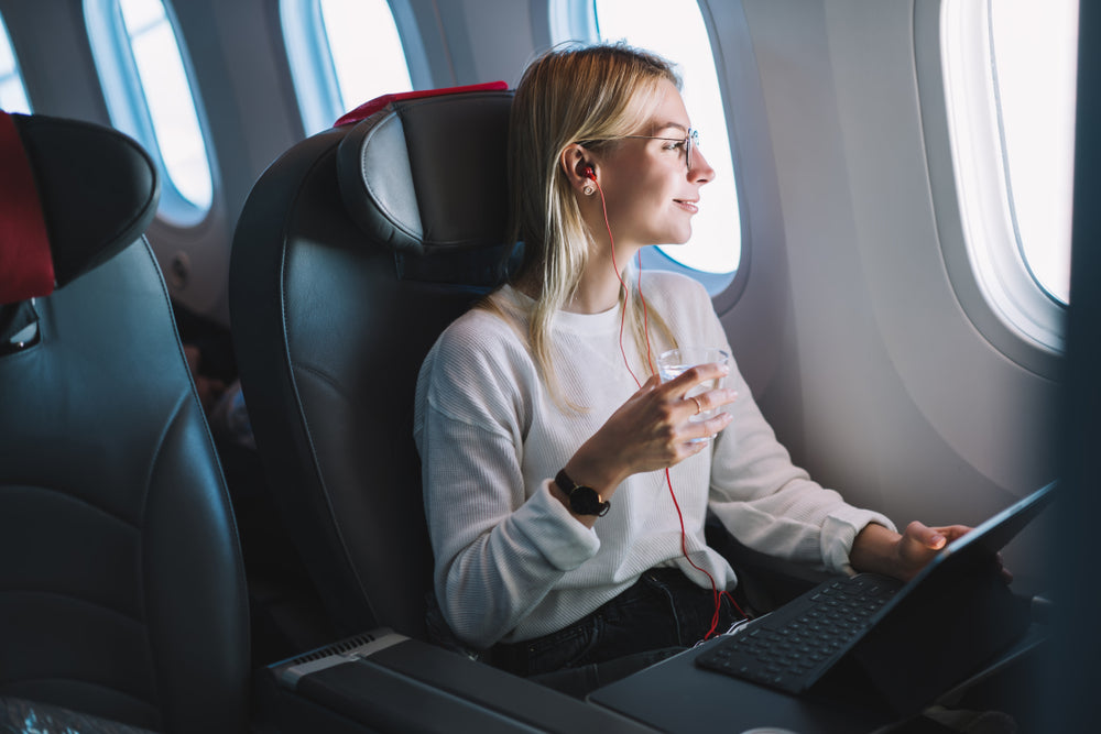 woman in airplane calmly looking out window