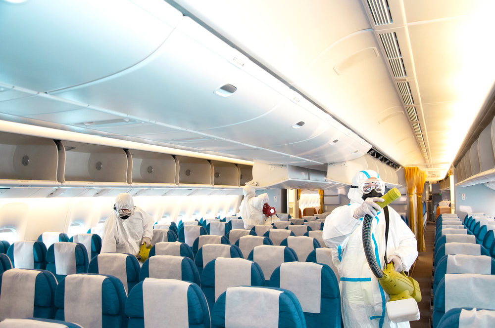 aircraft interior with sanitation crew during covid
