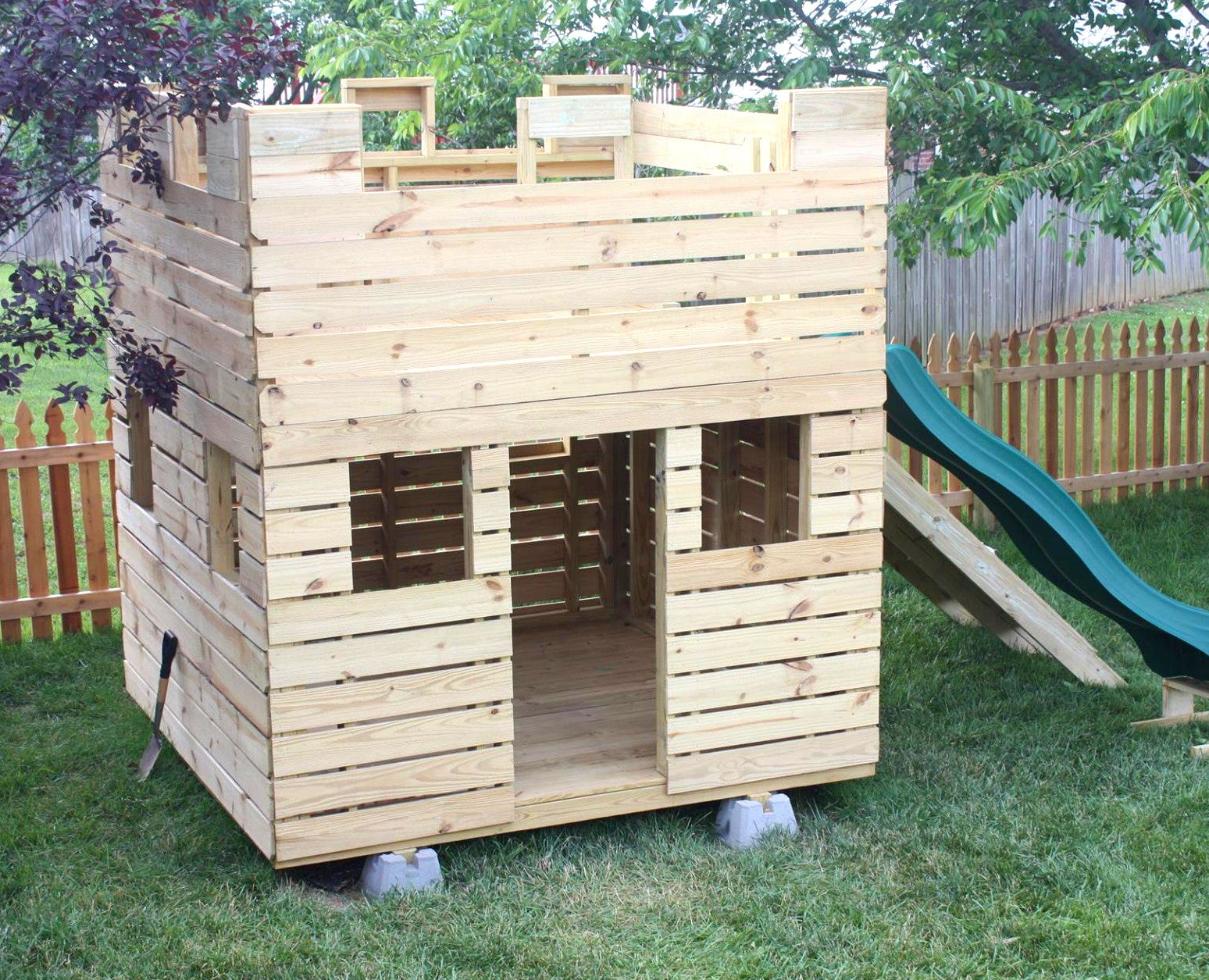 small outdoor playhouse with slide