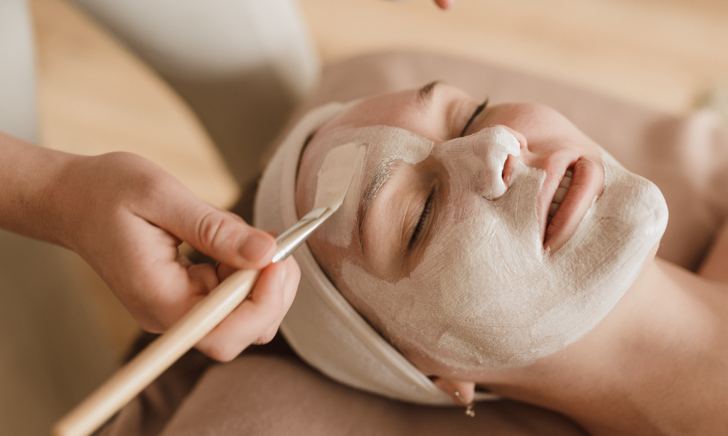 woman receiving face mask treatment