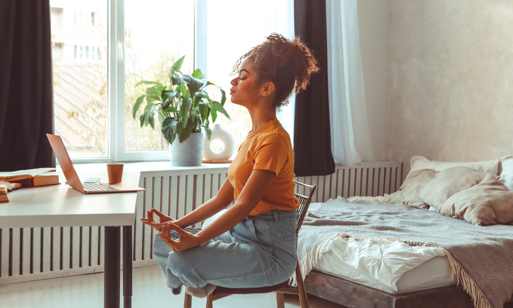 woman meditating by her desk