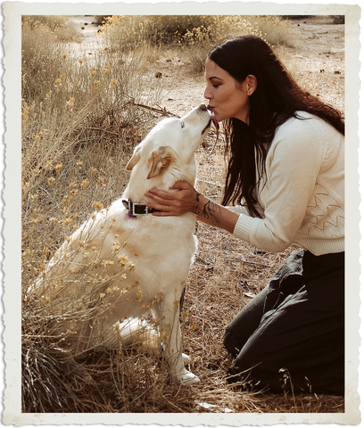 A Woman Hugs Her Dog in Our About Page Photo
