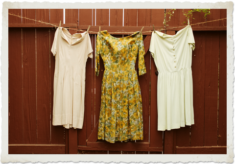 Vintage dresses hanging on a clothing line to dry
