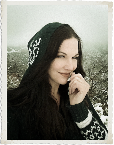 Portrait of a woman in a hooded sweater in the snow