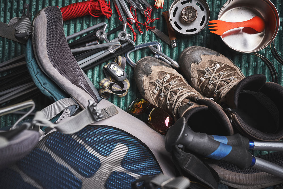 Backpacking gear laid out next to backpacking pack.