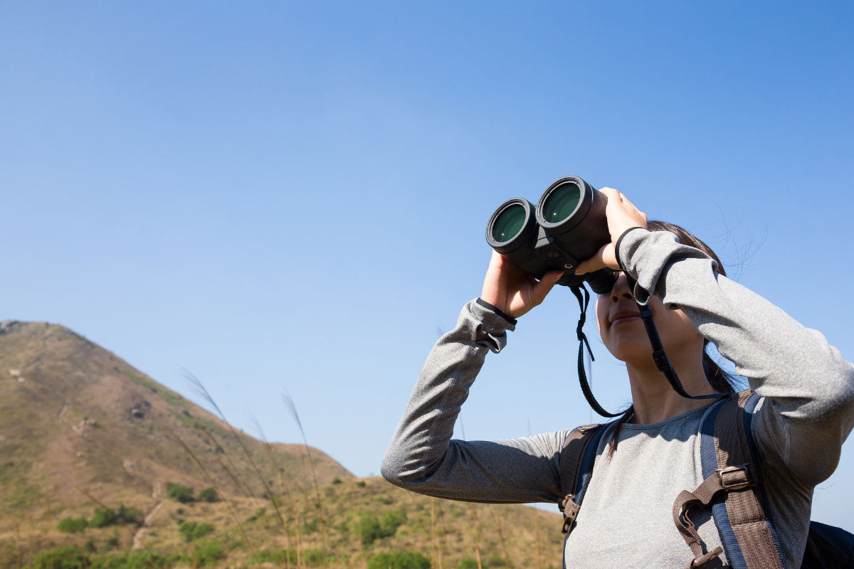 Hiker looking through binoculars.