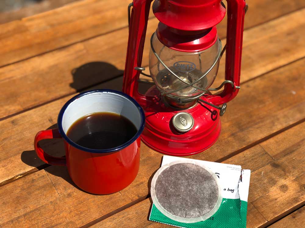 Enamel camp mug off coffee made with a pouch.