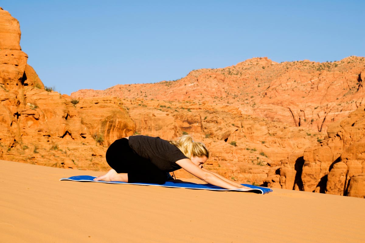 Hiker in child's pose to stretch feet.