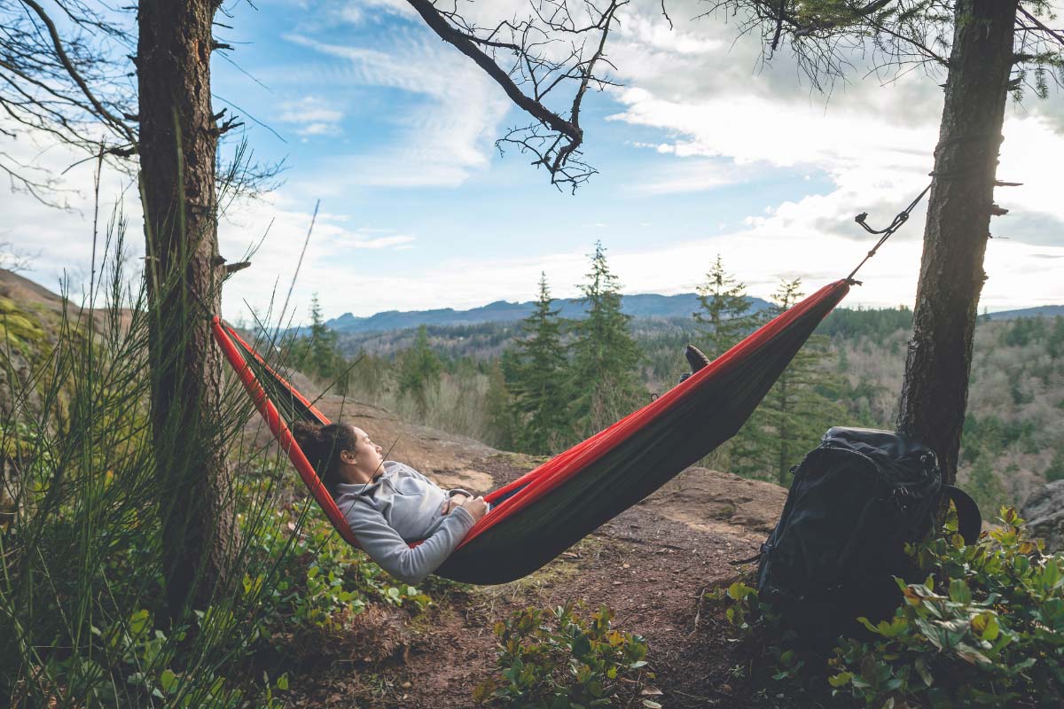 Hiker laying in a hammock hung perfectly.