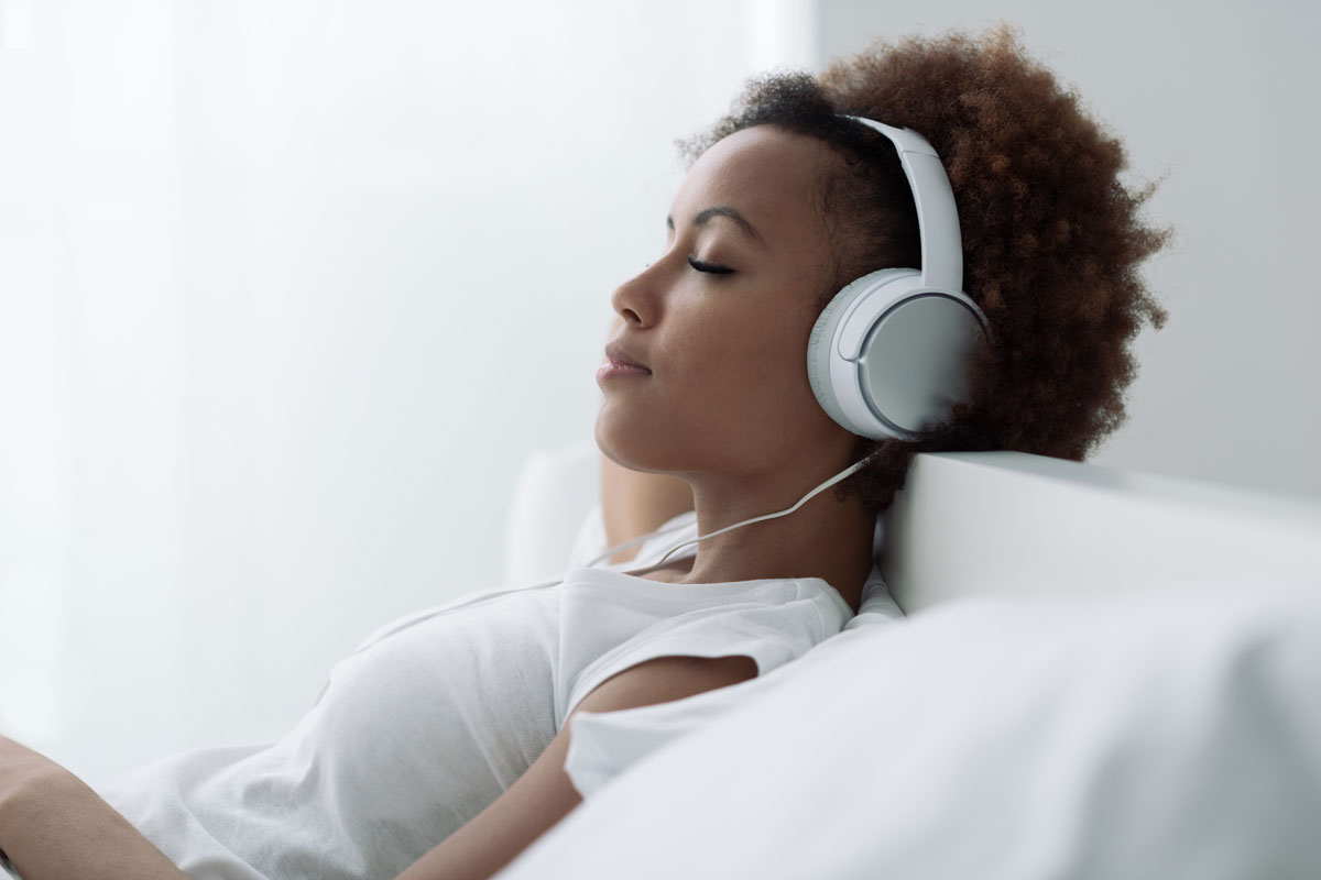 Women listening to a podcast with large headphones