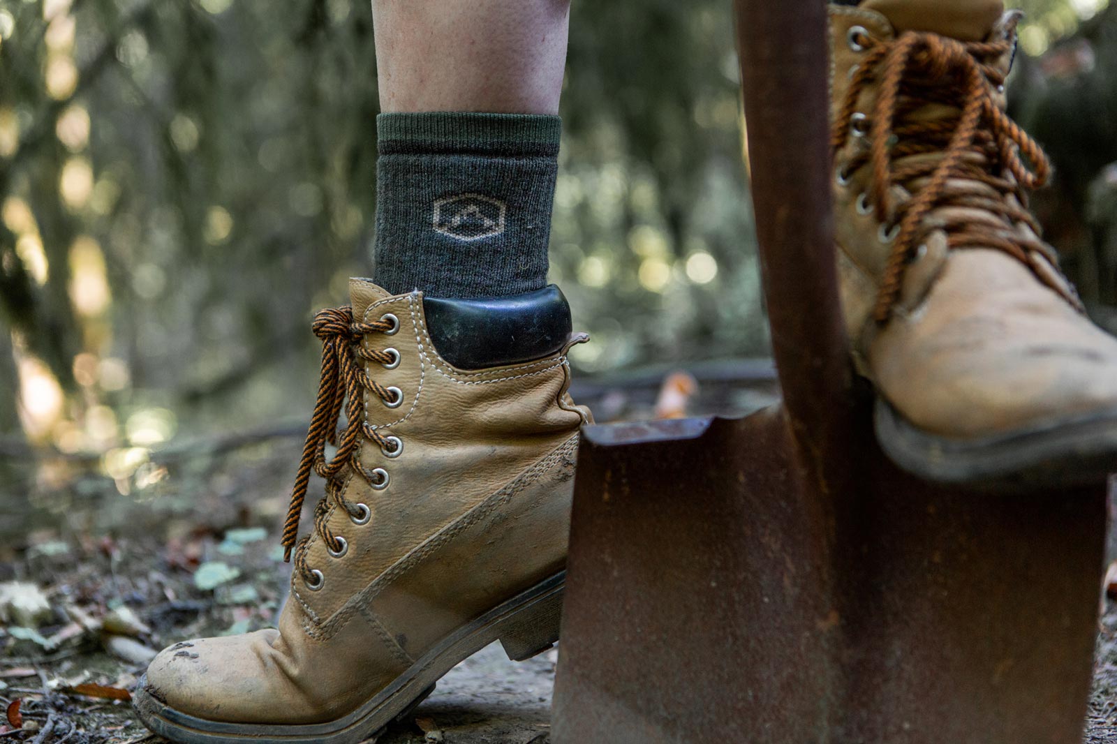 Women wearing Cloudline socks while using shovel.