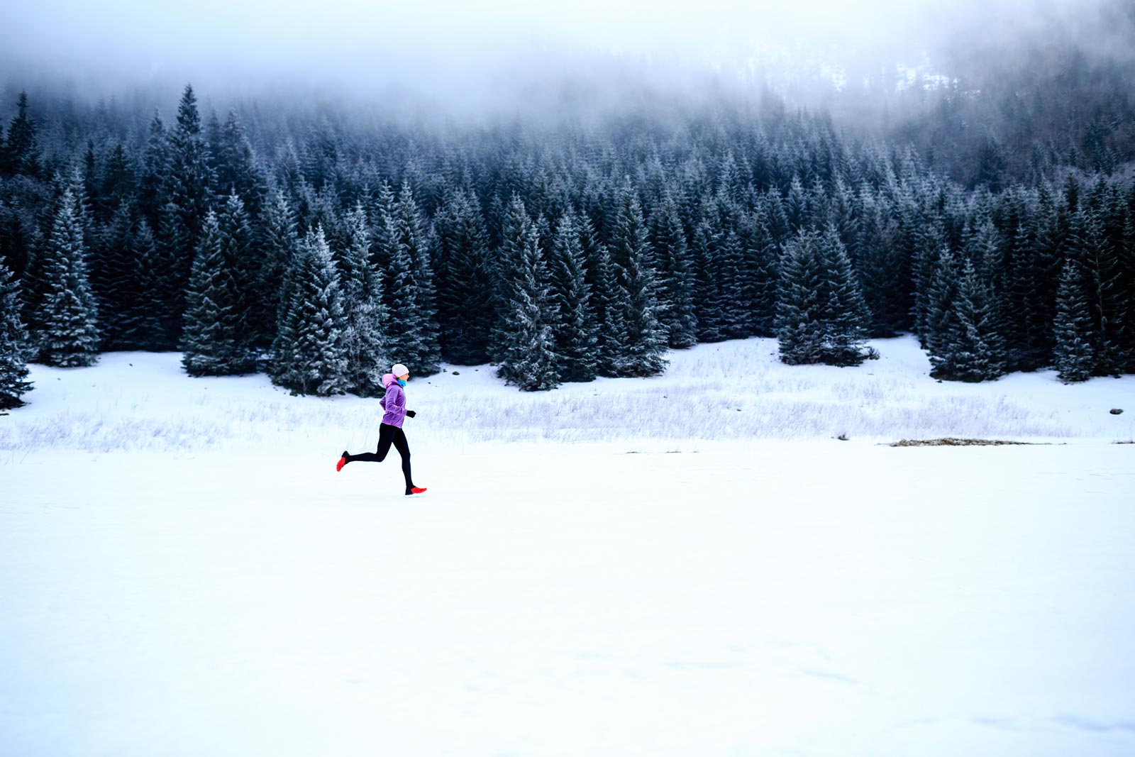 Women wearing Cloudline socks running in the snow