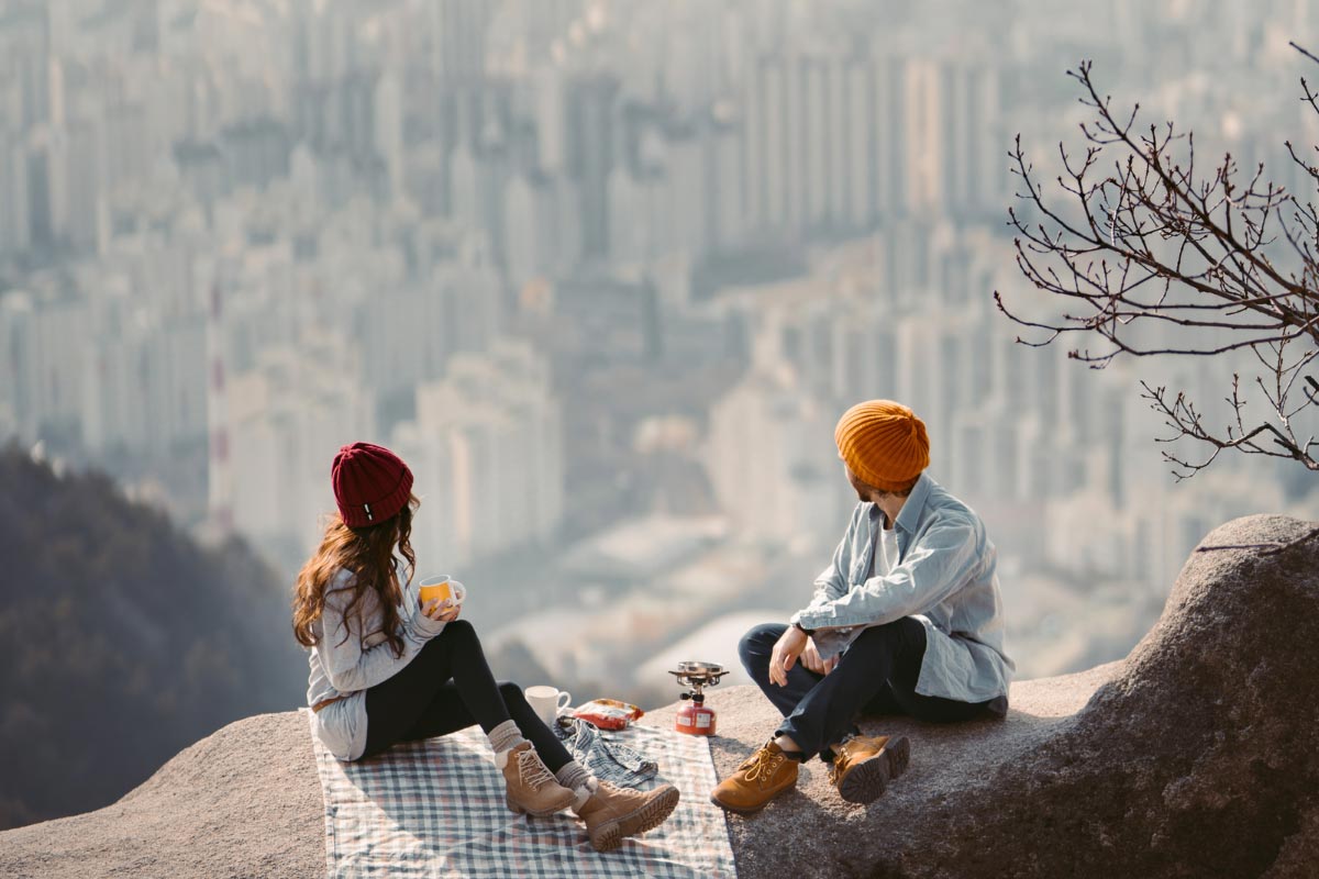 Couple having a mountain top picnic.