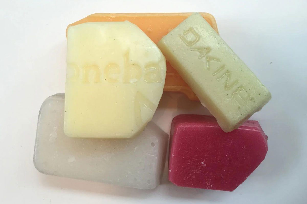 Assorted chunks of base wax in shades of white, yellow, and red.