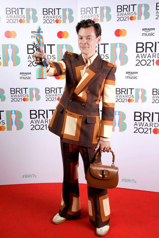 Harry styles carrying Gucci bamboo bag on the red carpet 