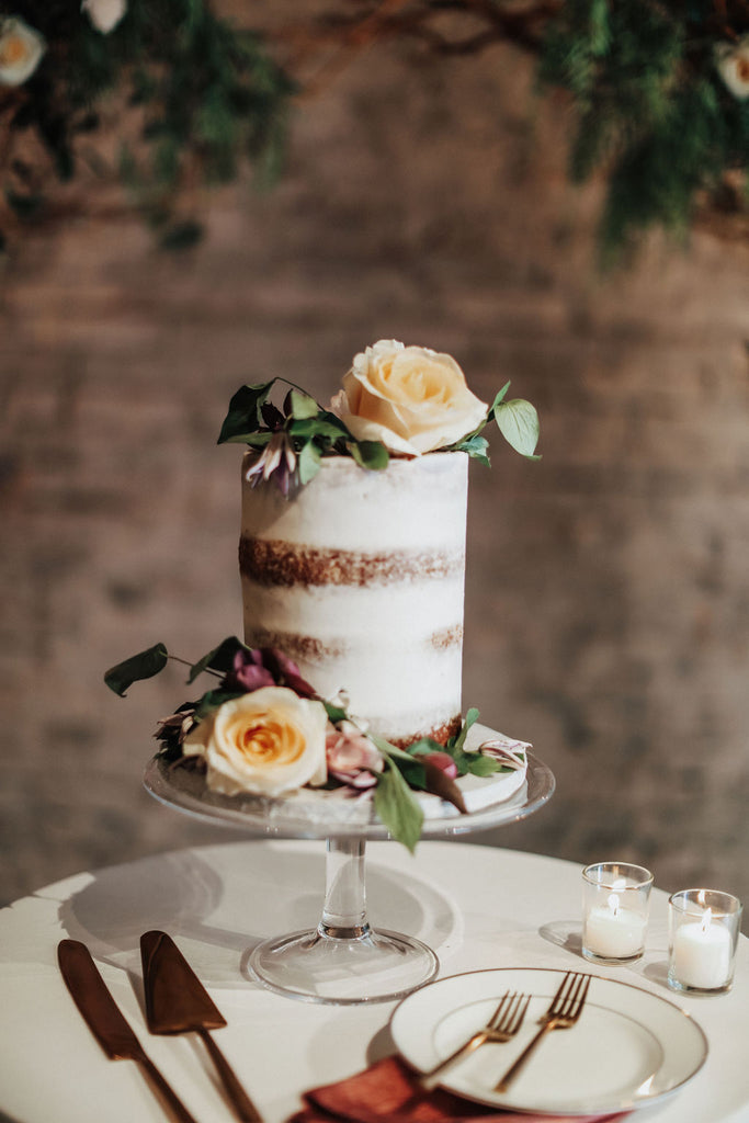 simple naked wedding cake with peach roses