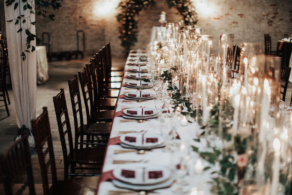 wedding reception with long tables and a lot of candles