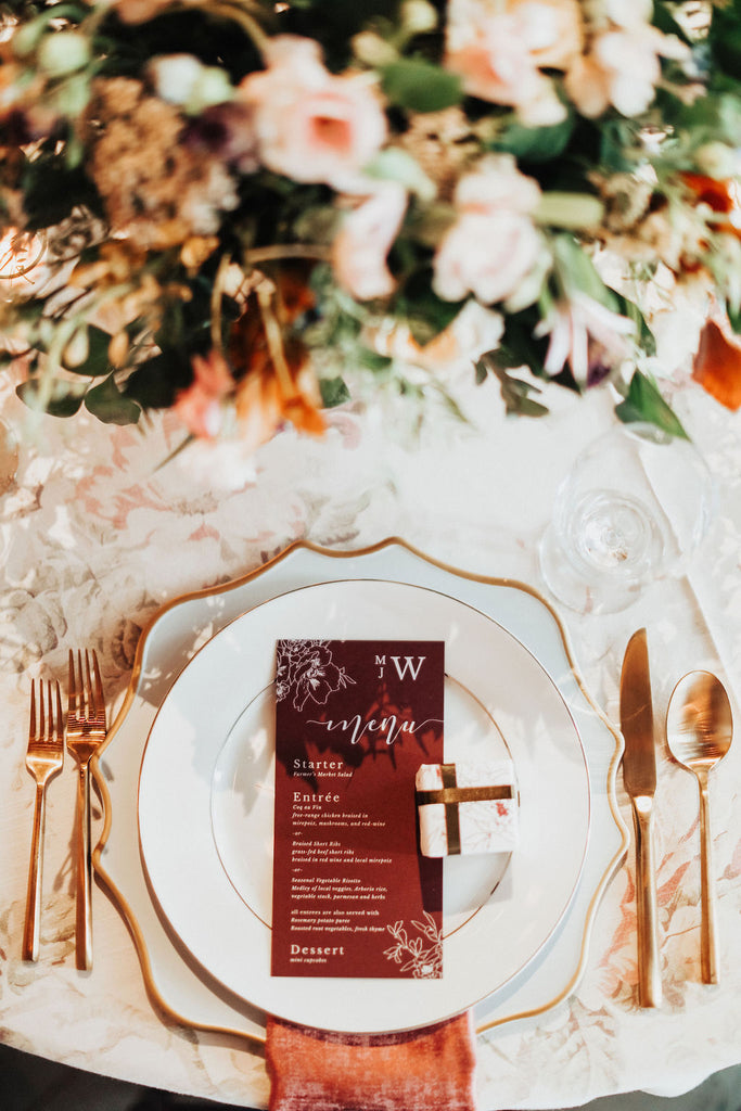 burgundy wedding menu with flowers and a monogram