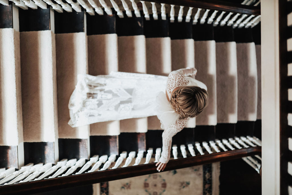 bride walking down the steps of a historic home wedding