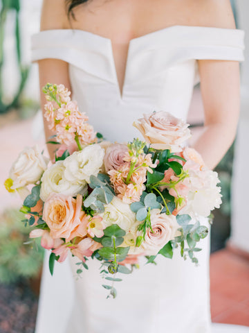 wedding bouquet with soft colored floras, peach, yellow, mauve, pink