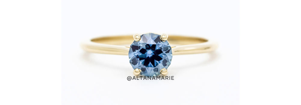 Cornflower blue sapphire engagement ring on yellow gold band