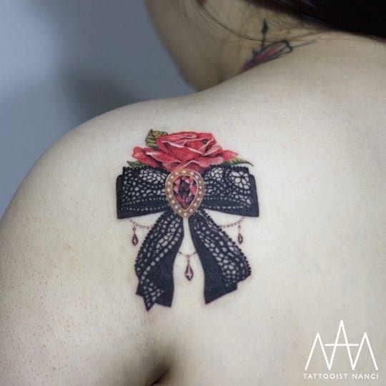 Lace Ribbon, Gemstone, and Rose Tattoo by Tattooist Nanci