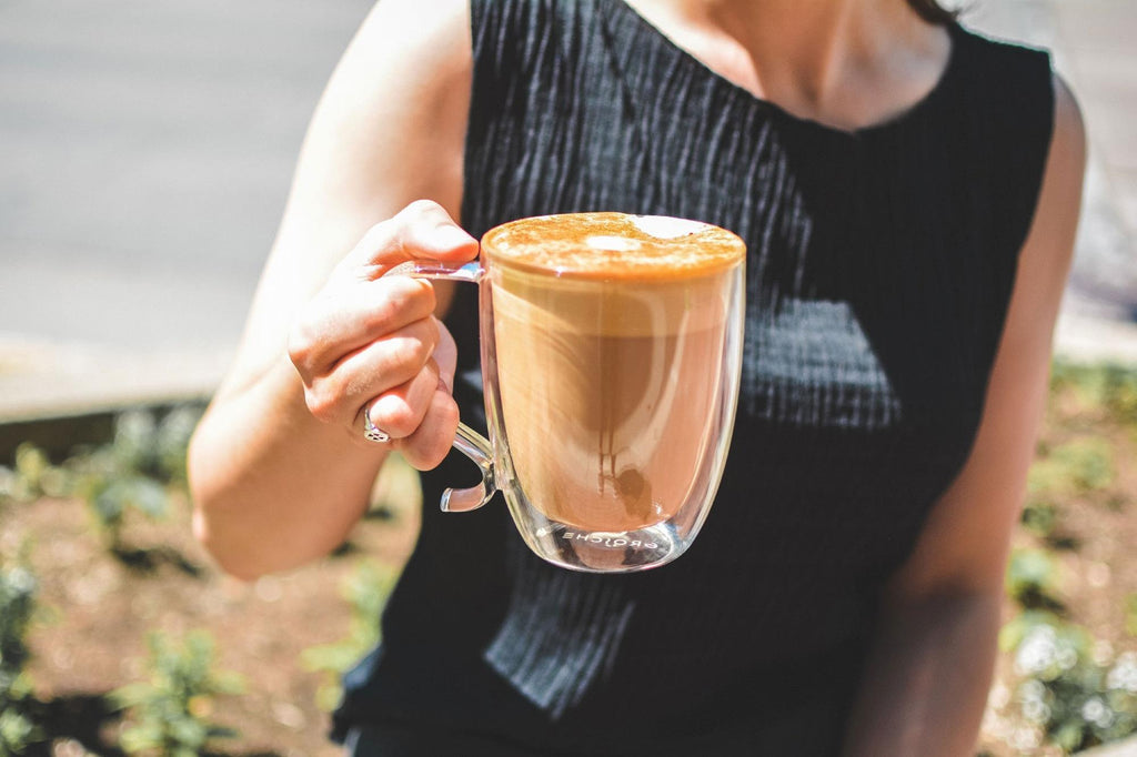 latte in a clear glass mug