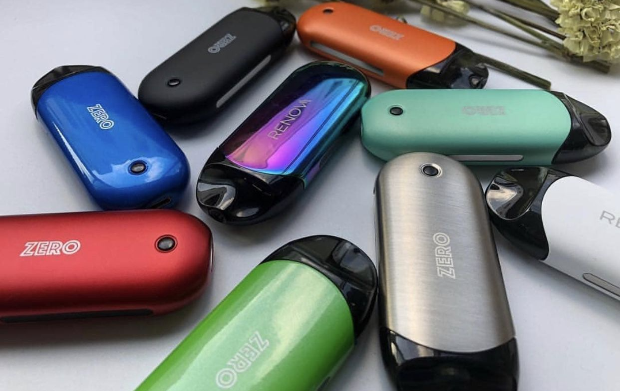 Several colorful Vaporesso vapes scattered atop a surface.