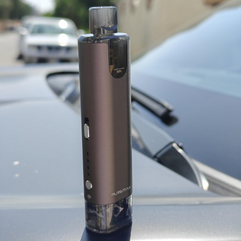One YIHI SXMini PureMax Pod System product placed vertically on the hood of a car.