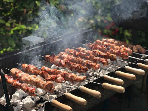 Souvlaki cooking over charcoal on a Cyprus BBQ