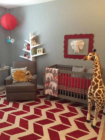 red safari nursery with april the giraffe