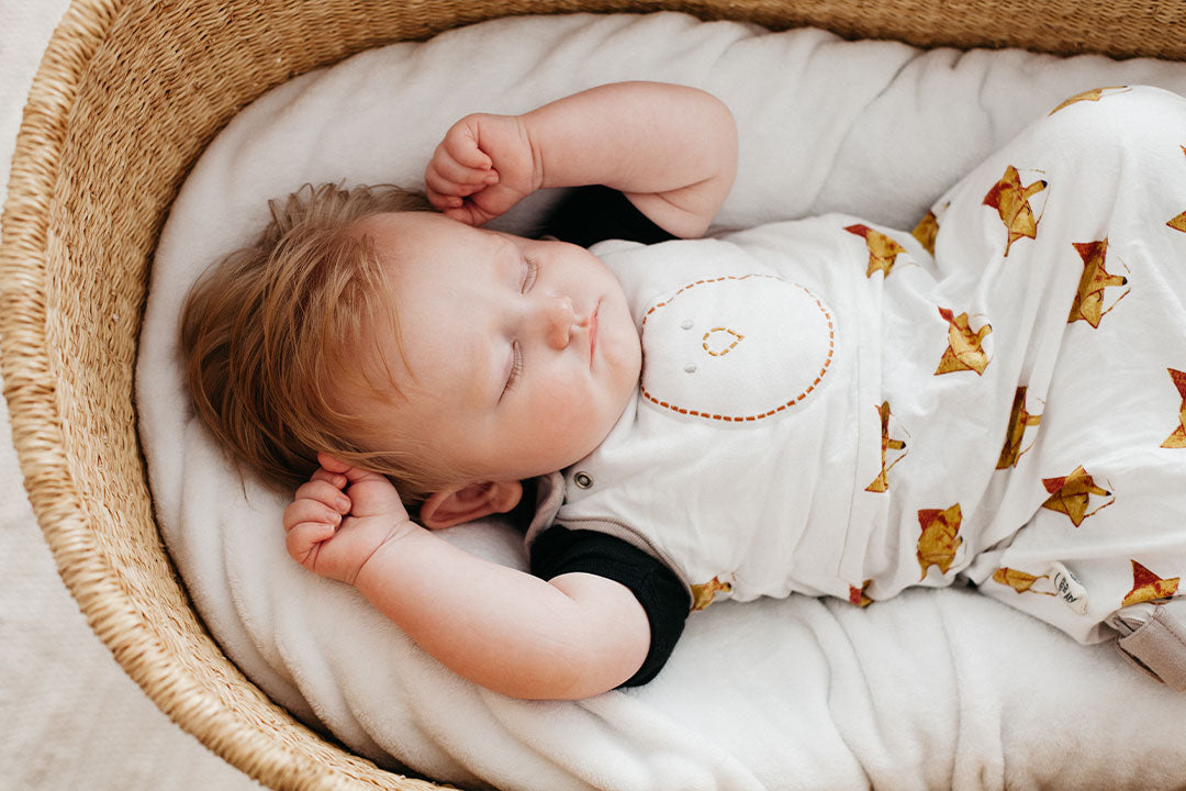 baby sleeping in bassinet with zen sack premier on