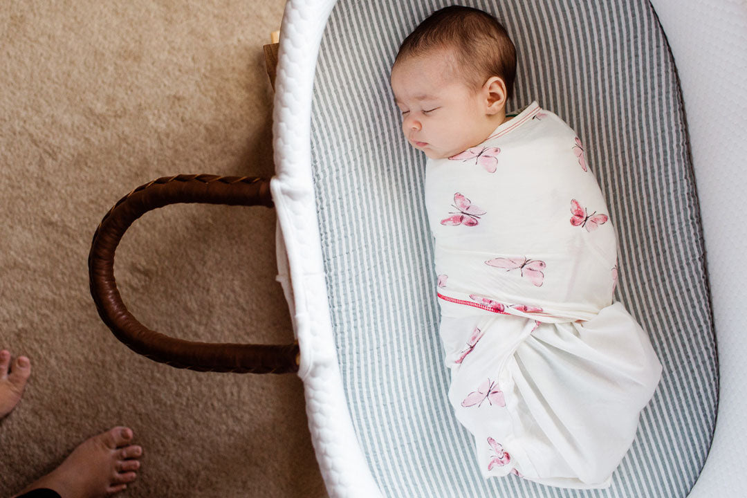 baby sleeping in zen swaddle premier in a bassinet