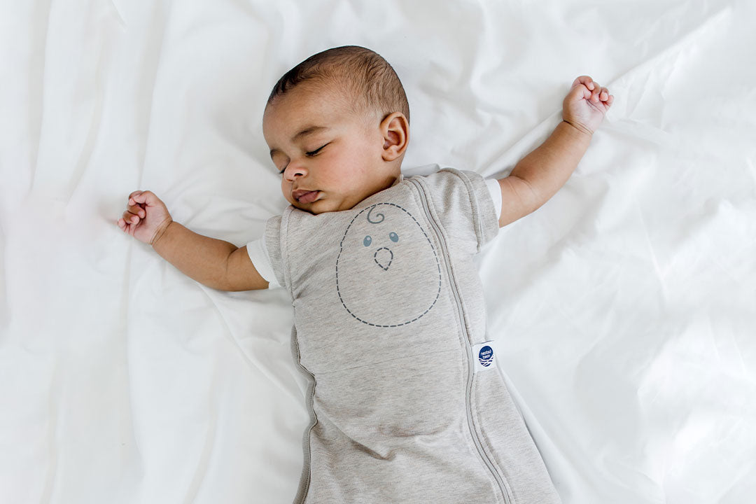 sleeping baby in zen one with both arms out