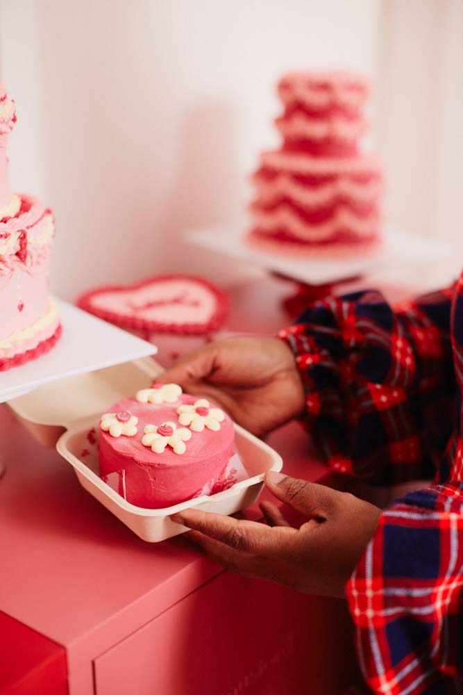 women holding decorative cake