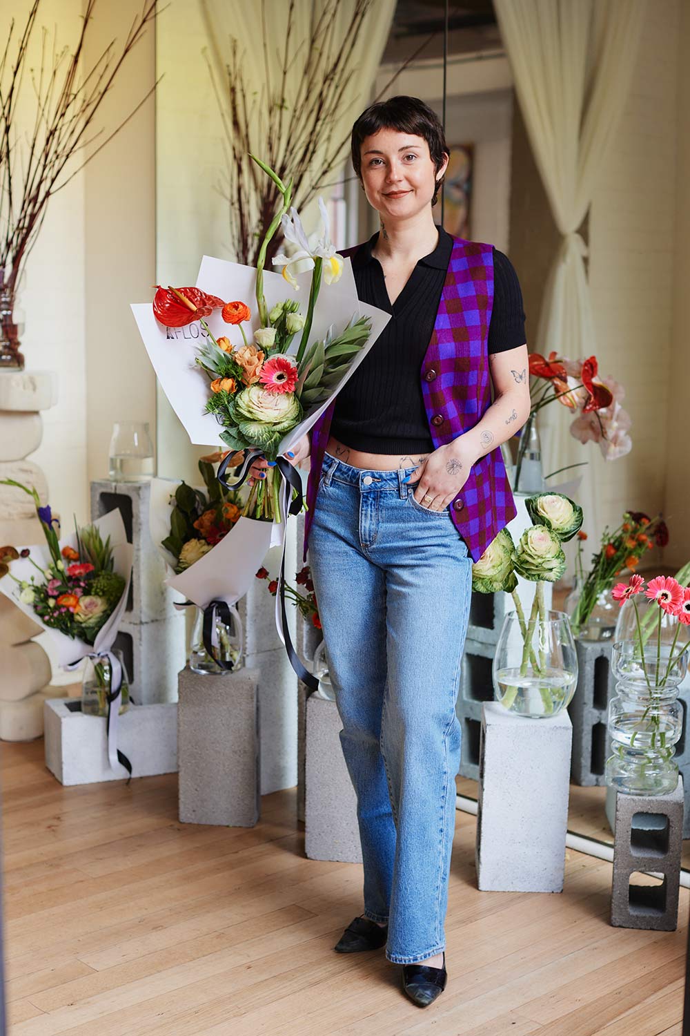 Kayla Moon wearing Mpito Vest standing inside Xflos florist