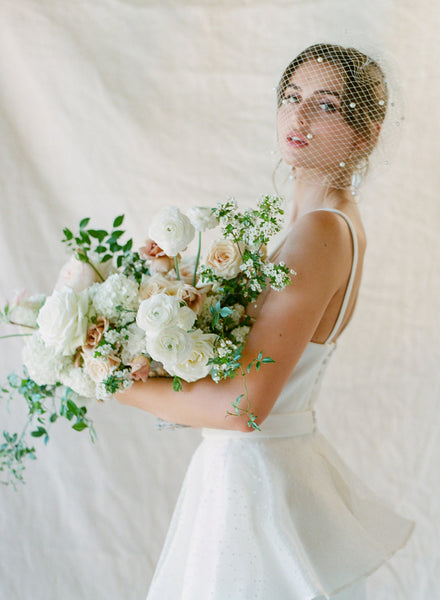 A bride wearing a birdcage veil