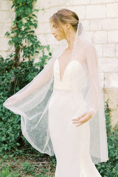 A bride wearing a pearl wedding veil